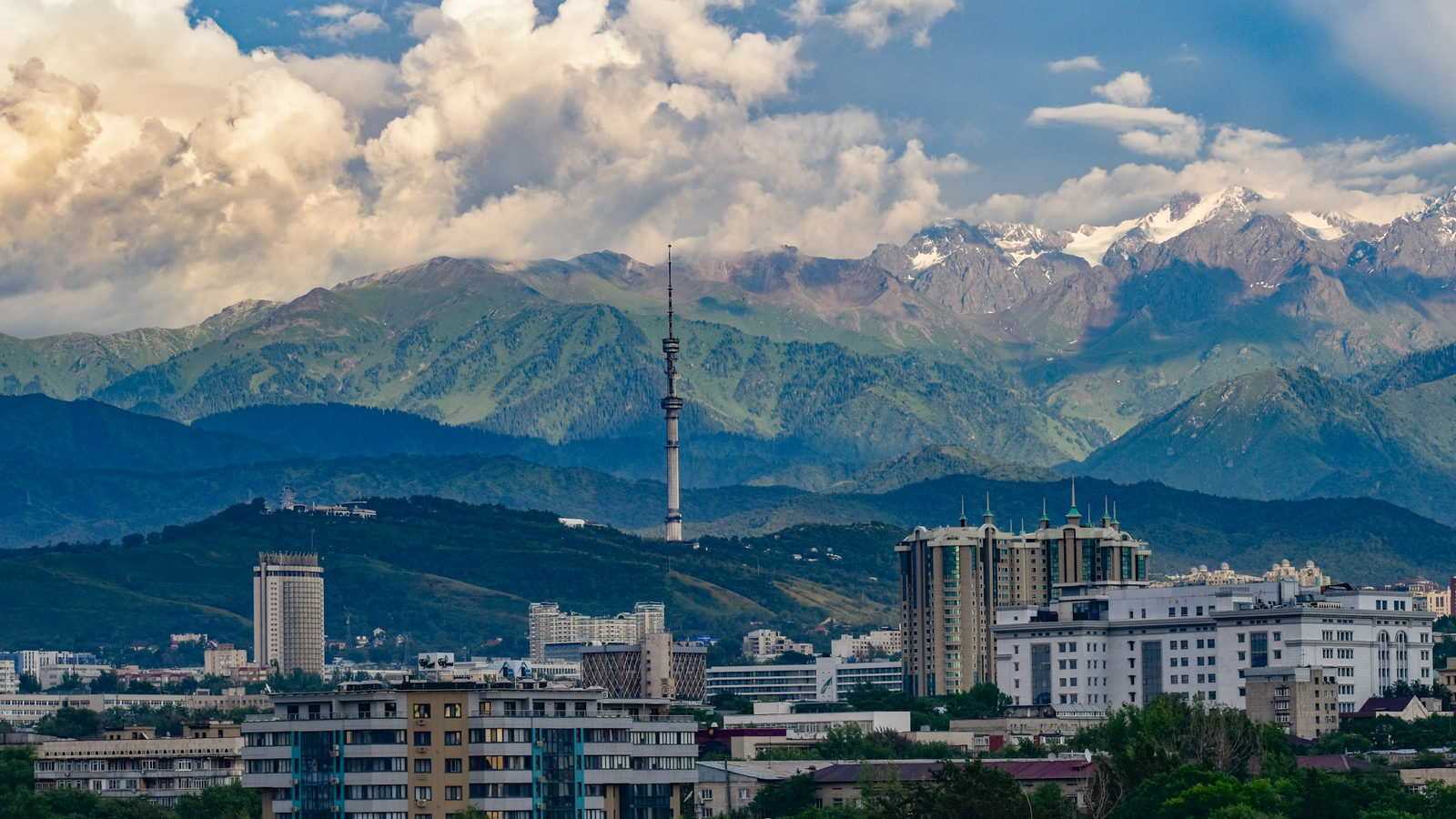 Almaty's skyline with the K&ouml;k-T&ouml;be television tower, backed by the snow-capped Trans-Ili Alatau range